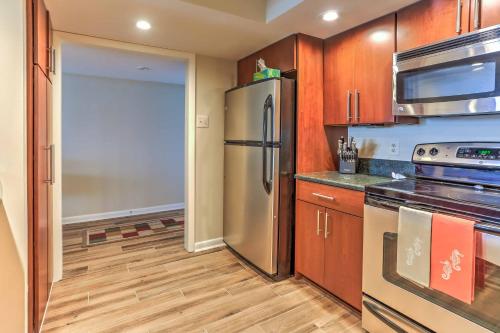 a kitchen with a stainless steel refrigerator and wooden cabinets at Chic Myrtle Beach Seaside Escape with Pool Access! in Myrtle Beach