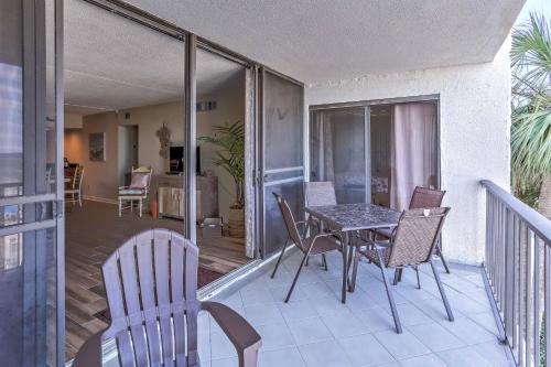 a patio with a table and chairs on a balcony at Chic Myrtle Beach Seaside Escape with Pool Access! in Myrtle Beach