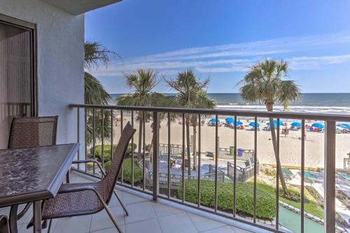 a balcony with a table and chairs and the beach at Chic Myrtle Beach Seaside Escape with Pool Access! in Myrtle Beach