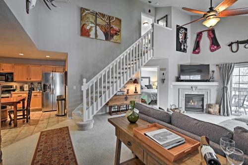 a living room with a couch and a table and a kitchen at Steamboat Springs Condo with Hot Tub and Ski Bus! in Steamboat Springs