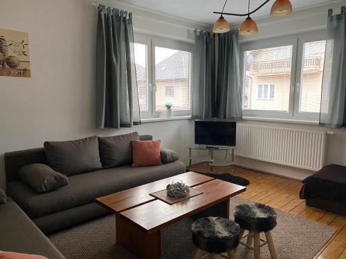 a living room with a couch and a coffee table at Apartmány Poliak in Liptovský Mikuláš