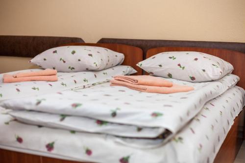two twin beds with pillows and towels on them at Smerekova Hata in Yablunytsya