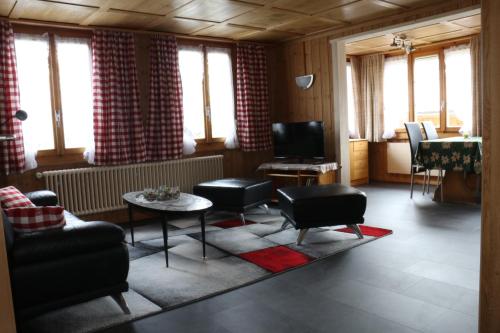 a living room with a couch and a table at Bühlerhof in Lenk