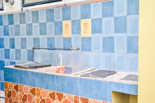 a blue and white tiled wall on a building at La Caverna House in Chemin Grenier