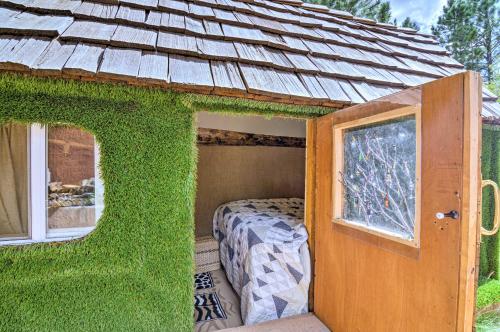 a small green house with a bed in it at Big Family Fun! Mtn Cabin Between Bryce and Zion in Long Valley Junction