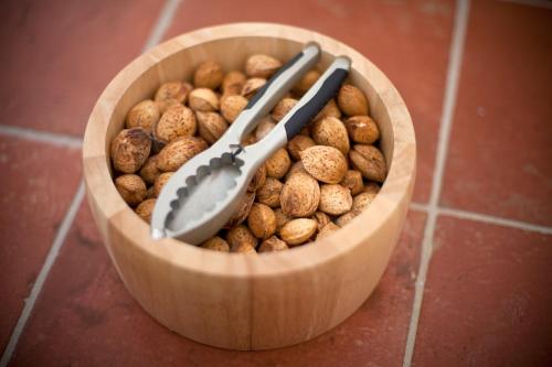 a wooden bowl filled with peanuts and a clock in it at Monte do Giestal - Casas de Campo & Spa in Abela