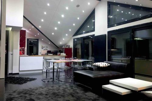 a living room with a couch and a table in a kitchen at Ioannina Luxury Suites & Apartments in Ioannina
