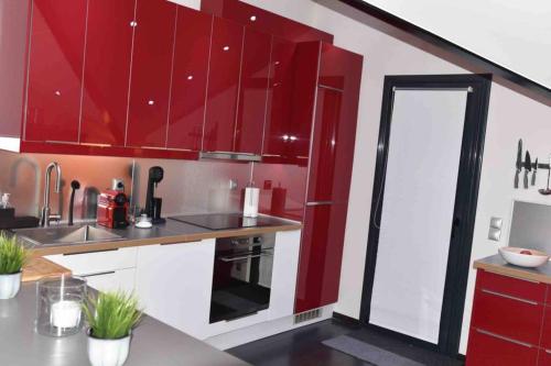 a kitchen with red cabinets and a sink at Ioannina Luxury Suites & Apartments in Ioannina
