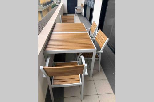 a row of wooden tables and chairs on a balcony at Ioannina Luxury Suites & Apartments in Ioannina