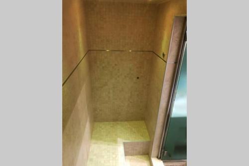 a walk in shower in a room with a glass door at Ioannina Luxury Suites & Apartments in Ioannina