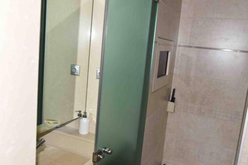 a bathroom with a shower with a glass door at Ioannina Luxury Suites & Apartments in Ioannina