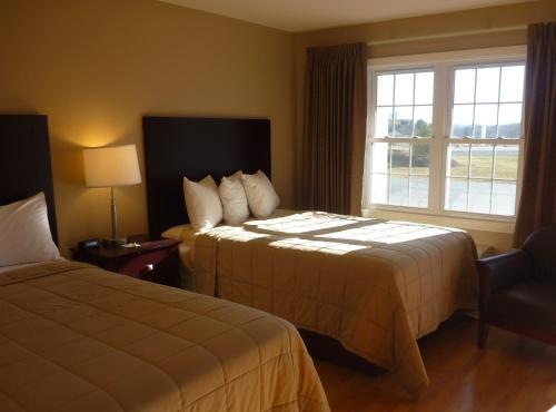 um quarto de hotel com duas camas e uma janela em Yankee Clipper Motel em Belfast