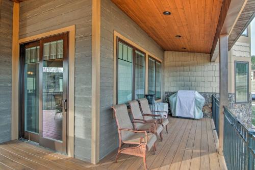 a porch with chairs and a wooden ceiling at Bella Greens Spacious Sturgis Home with Large Deck in Sturgis