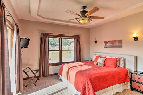 um quarto com uma cama com um cobertor vermelho e uma janela em Sturgis Vacation Rental with Hot Tub and Game Room! em Sturgis
