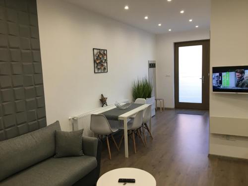 a living room with a couch and a table at Főtér apartman II. in Villány
