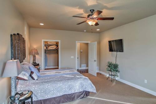 a bedroom with a bed and a ceiling fan at Bella Greens Spacious Sturgis Home with Large Deck in Sturgis