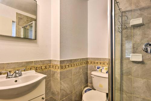 a bathroom with a toilet and a sink and a shower at Sandford Vacation Rental Near Airport and Lake! in Sanford