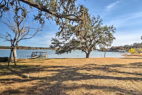 two trees in a field next to a body of water at Tow Retreat on Lake Buchanan with Dock and Kayaks! in Tow