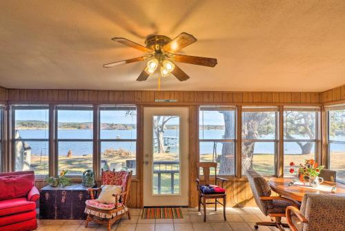 a living room with a ceiling fan and windows at Tow Retreat on Lake Buchanan with Dock and Kayaks! in Tow