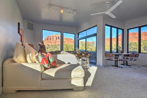 
a living room filled with furniture and a window at 2-Acre Sedona Casita with Deck and Red Rock Views! in Sedona
