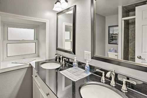 a bathroom with two sinks and two mirrors at Historic Laramie Condo - 3 Blocks to Downtown and UW in Laramie