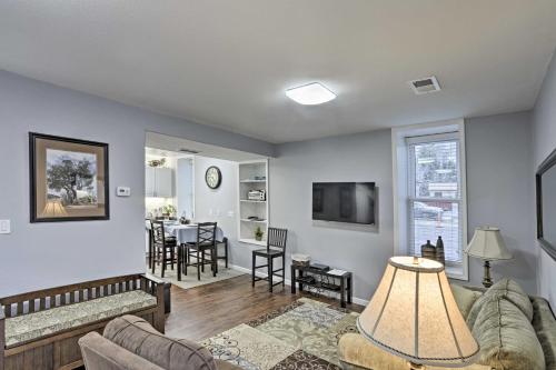 a living room with a couch and a table at Historic Laramie Condo - 3 Blocks to Downtown and UW in Laramie