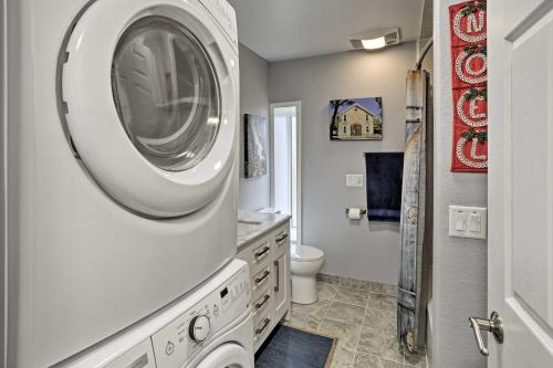 a washer and dryer in a bathroom with a toilet at Historic Laramie Condo - 3 Blocks to Downtown and UW in Laramie