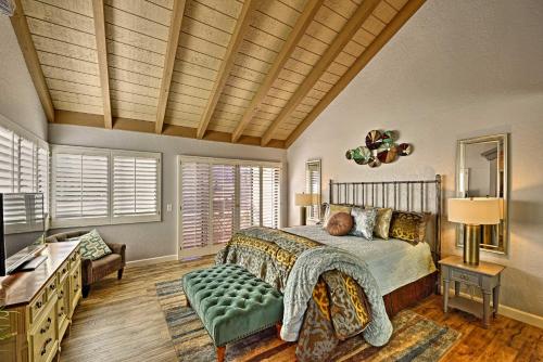 a bedroom with a bed and a dresser and a television at Palm Springs Townhome with Pool and Golf Access! in Palm Springs