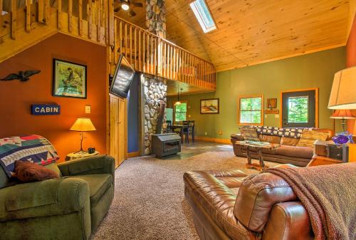 a living room with a couch and chairs in a house at Trout Lake Cabin with Private Dock, Kayaks and Loft! in Grand Rapids