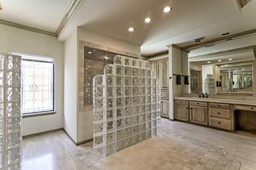 a bathroom with a shower with a glass wall at Lakefront Harlingen Home with Pool, Yard and Pool Table in Harlingen