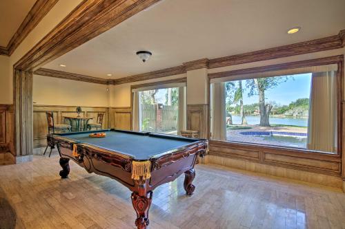 a pool table in a room with a large window at Pool and Hot Tub Lakefront Harlingen Home in Harlingen
