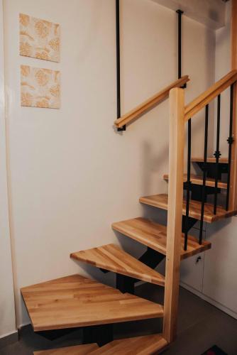 a staircase in a house with wooden steps at Shkodra apartment with amazing view in the city center in Shkodër