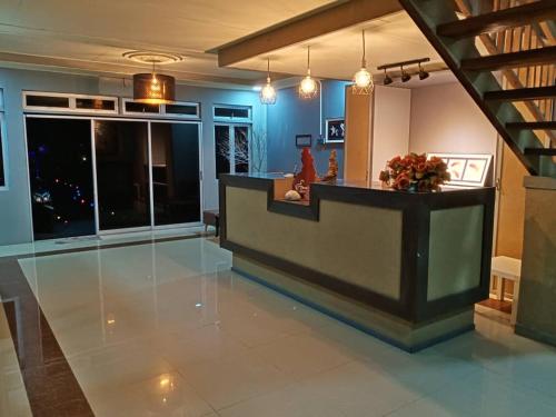 a lobby with a reception desk and a staircase at Tamara Village Tioman in Kampong Juara
