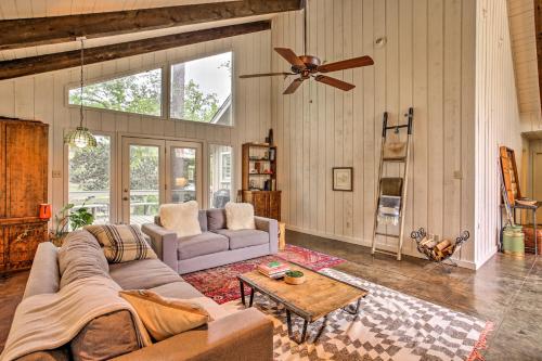 a living room with a couch and a table at Pet-Friendly Lake Athens Home with Fireplace! in Athens