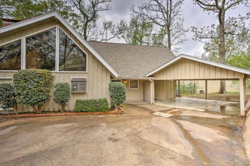 a house with a garage with a driveway at Pet-Friendly Lake Athens Home with Fireplace! in Athens