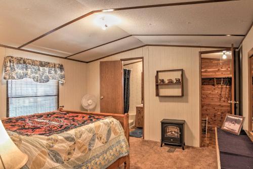 a bedroom with a bed and a fireplace at Cloudcroft Cabin with Deck Near Skiing and Fishing! in Cloudcroft