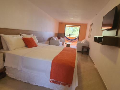 A bed or beds in a room at Pousada Maraoka