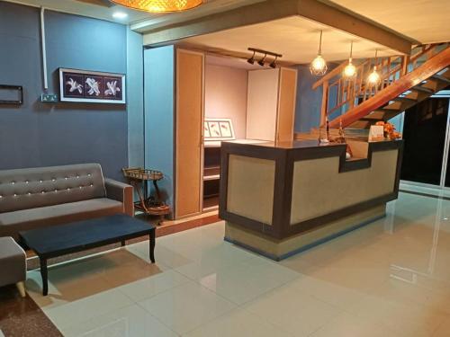 a living room with a bench and a staircase at Tamara Village Tioman in Kampong Juara