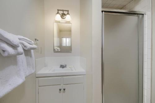 a white bathroom with a sink and a shower at 25A Villarreal Retreat in Wawona