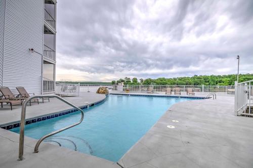 a swimming pool on the side of a building at Lake Views and Pool Access Osage Beach Condo in Osage Beach