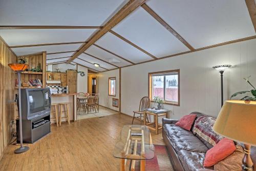 a living room with a couch and a tv at Columbia Falls Home about 22 Mi to Glacier Natl Park! in Columbia Falls