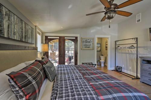 a bedroom with a bed and a ceiling fan at Home with Jacuzzi 10 Mi to NAU and Flagstaff! in Mountainaire