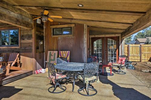 a patio with a table and chairs on a house at Home with Jacuzzi 10 Mi to NAU and Flagstaff! in Mountainaire