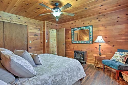 a bedroom with a bed and a fireplace in a cabin at Cozy Home with Patio Near Yosemite National Park! in Mariposa