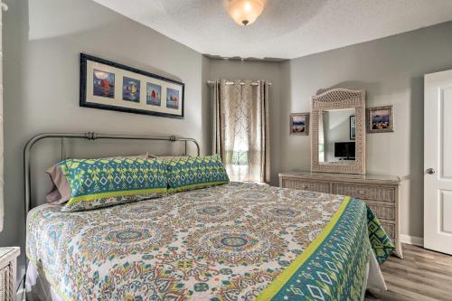 a bedroom with a bed and a mirror at Beachfront Gulf Shores Condo with Pool in Gulf Shores