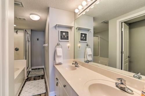 a bathroom with a sink and a large mirror at Beachfront Gulf Shores Condo with Patio, Pool Access in Gulf Shores