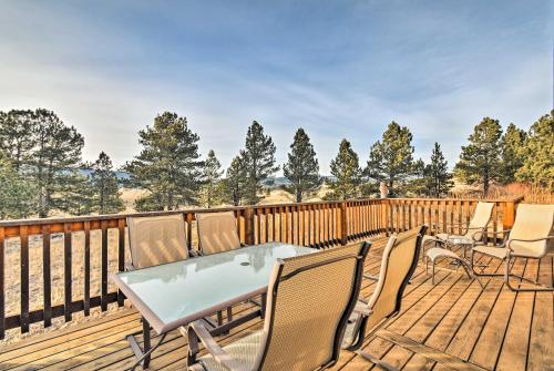 a wooden deck with chairs and a table on it at Eagle Nest Home with Hot Tub and Views - 5 Min to Lake in Eagle Nest
