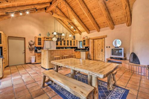 a dining room with a table and a kitchen at Eagle Nest Home with Hot Tub and Views - 5 Min to Lake in Eagle Nest