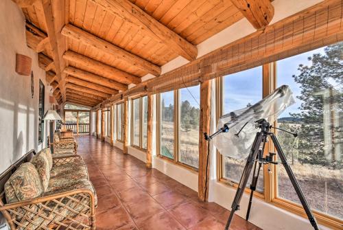 a camera on a tripod in a room with windows at Eagle Nest Home with Hot Tub and Views - 5 Min to Lake in Eagle Nest