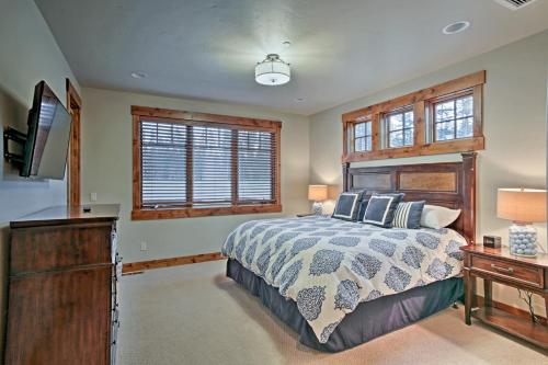 a bedroom with a bed and a dresser and windows at Cle Elum Home on Golf Course with Fire Pit and Hot Tub in Cle Elum